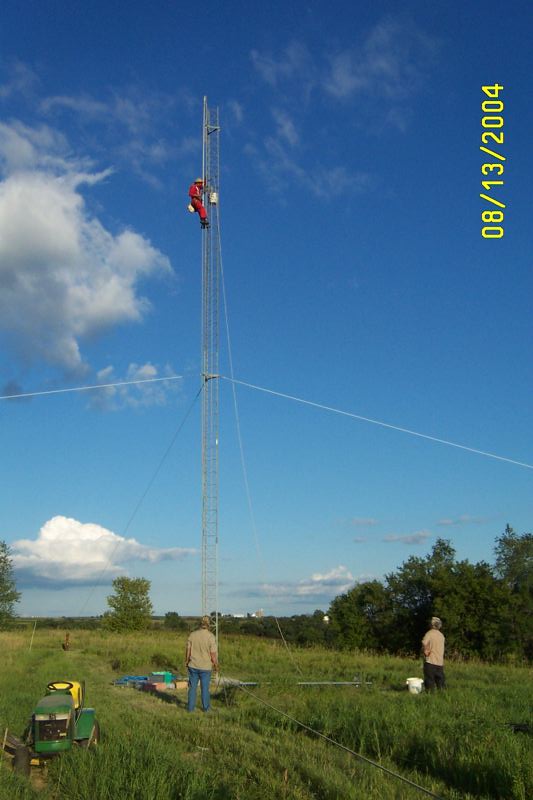 W0AIH on the tower, getting ready to raise the gin pole.