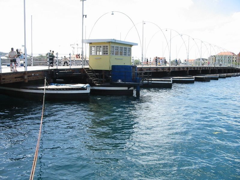 Queen Emma Pontoon Bridge  a floating pedestrian bridge that swings open for passing ships and boats.